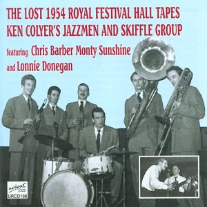 Black and white photo of seven suited men with jazz instruments on a light blue background.