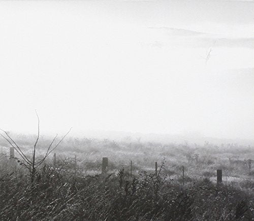 CD album cover with dark, gothic text on a faded, sepia-toned landscape background.
