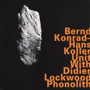 A white rock on a black background with orange text to the right.