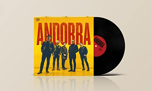 Yellow album cover with a band photo and a black vinyl record.