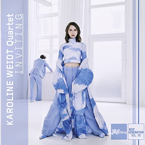 CD cover featuring a woman in blue patterned clothing, standing by windows.