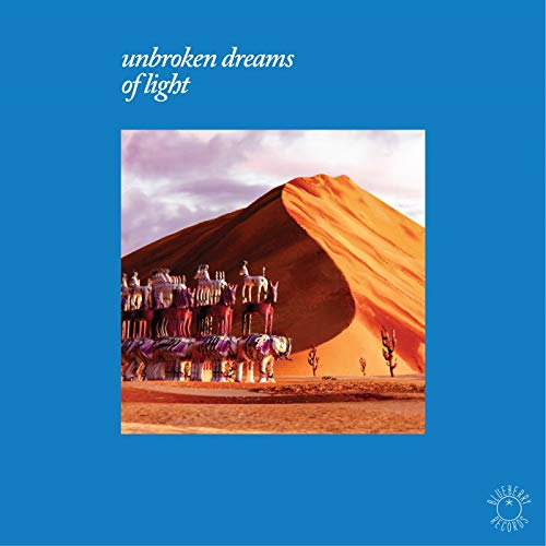 Vinyl record cover: desert landscape with a surreal, stacked caravan.