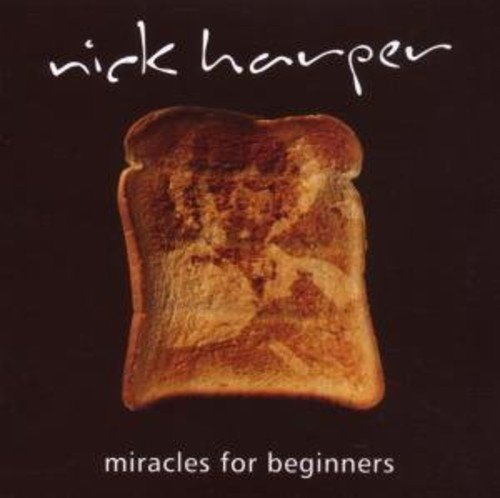 "Album cover featuring a toasted slice of bread against a black background."
