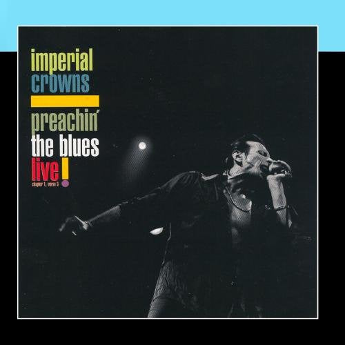 "Album cover with a man singing into a microphone, black background, multicolored text."