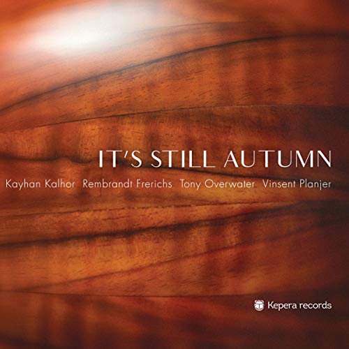 "CD cover with 'It's Still Autumn' title on a wooden background."