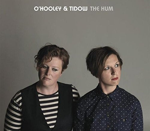 CD cover featuring two women with neutral expressions against a grey background.