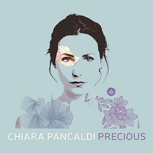 "Album cover featuring a woman's face with floral elements on a teal background."