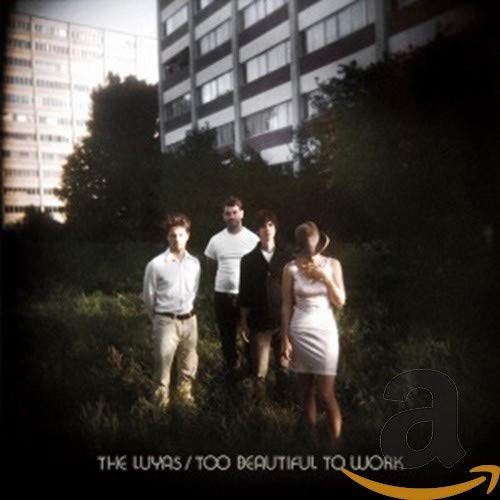 CD cover: four people stand in overgrown foliage before a building.
