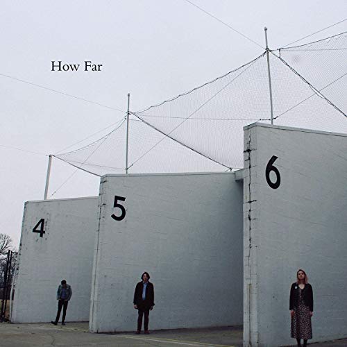 "Album cover with three people standing in front of numbered white concrete structures."