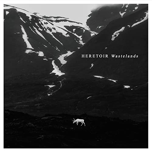 Black and white landscape with mountains, text, and a lone deer.