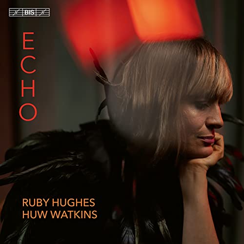CD cover: Woman with feathers, red background, text “Echo” and artist names.