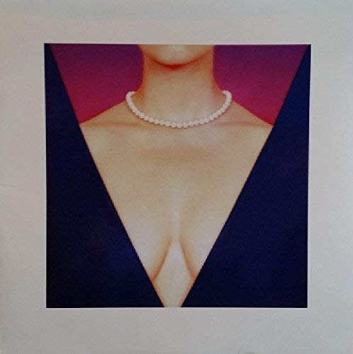 A woman's neck and chest wearing a pearl necklace against a red background.