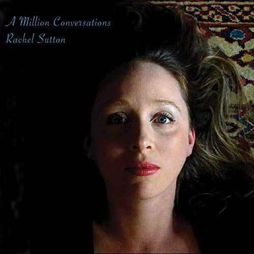 "CD cover featuring a woman lying on a patterned rug, looking directly at the camera."