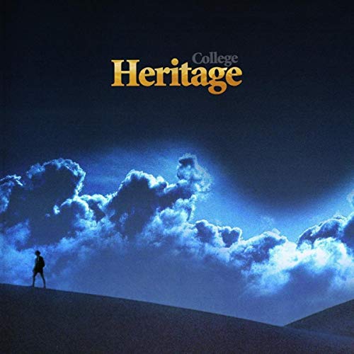 A silhouette of a person walking on a dark hill under glowing blue clouds.