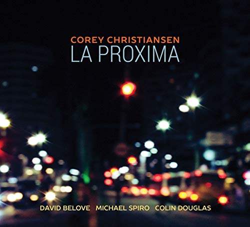 "Album cover with blurred cityscape at night and white and orange text."