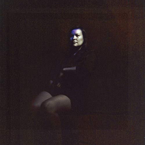 Dark portrait of a woman in shadow, album cover for Suuns’ “Hold/Still Remixes”.