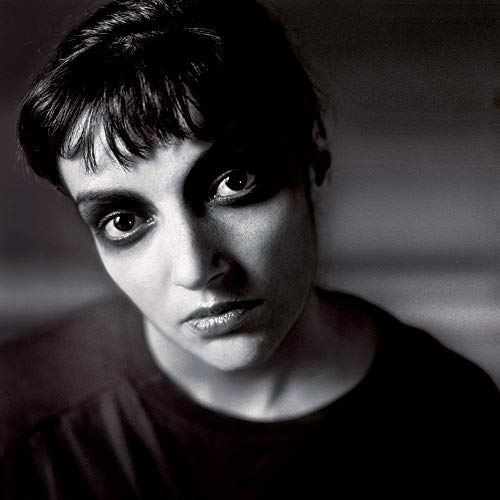 Black and white portrait of a person with intense, dark eyes.