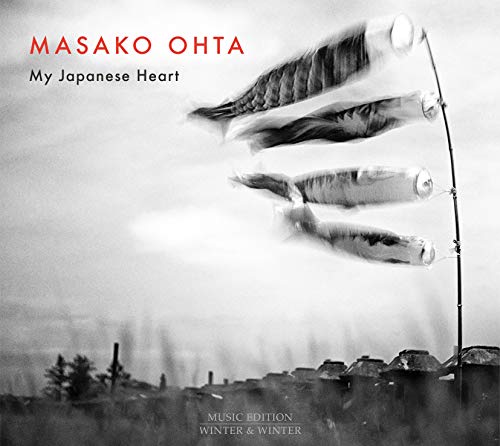 "Album cover with black-and-white image of wind chimes and a cloudy sky."