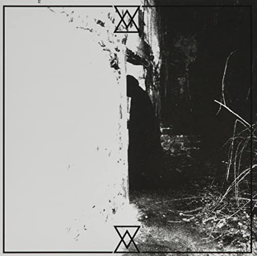 Dark album cover with a hooded figure beside a bright wall.