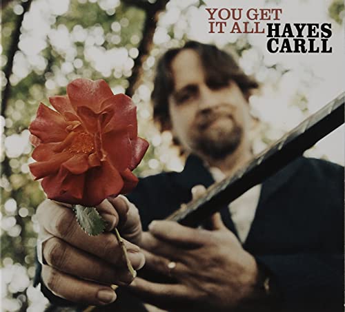 Hayes Carll album cover with a man holding a red rose and guitar.