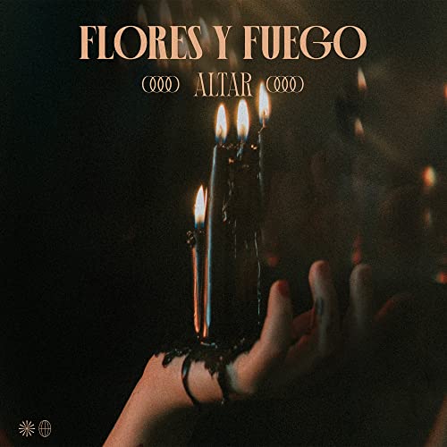 Burning candles held by a hand, dark background, album cover art.