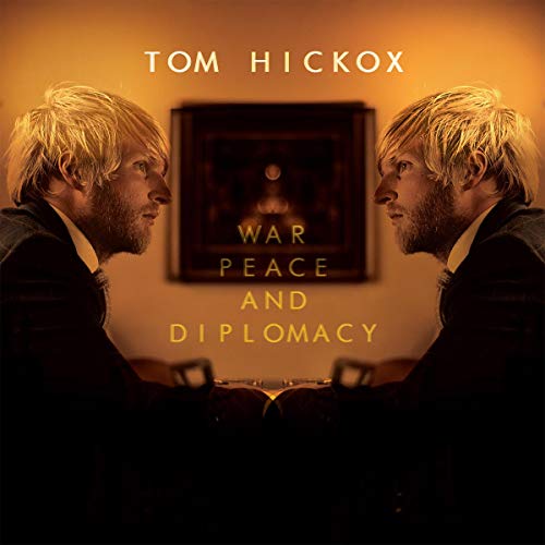 "Album cover with mirrored image of man and 'War, Peace and Diplomacy' text."