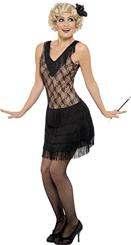 Woman wearing a black flapper costume, fishnet stockings, and heels, holding a conductor's baton.