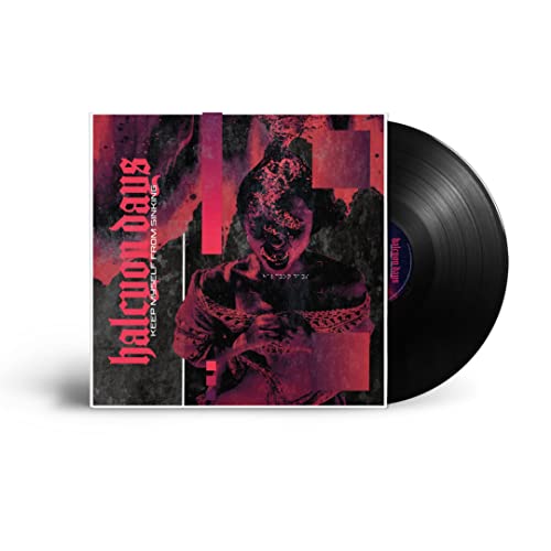 Vinyl record with album cover featuring a distressed, abstract portrait.