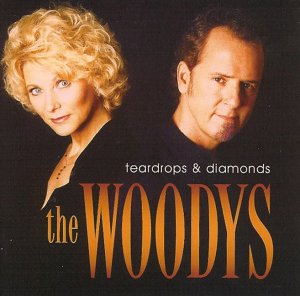 CD cover with blonde woman and dark-haired man, "the Woodys" in large orange text.