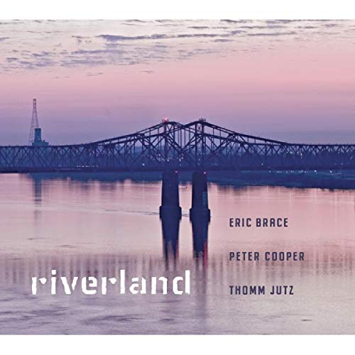 "Album cover with a bridge over water at dusk, artist names listed."