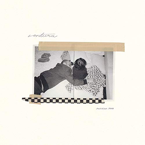 "Album cover with black and white photo of a man lying on a bed."