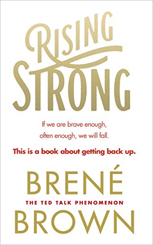 "Rising Strong book cover with gold title and author name, white background, red subtitle text."