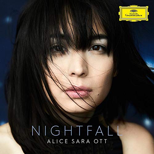 Album cover with a close-up of a woman with dark hair and blue background.