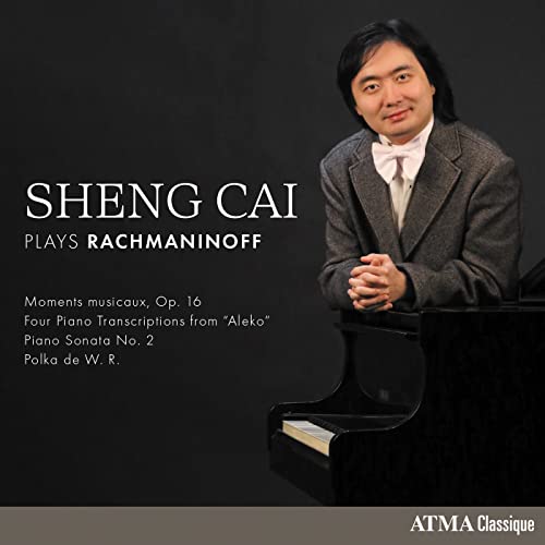 Pianist Sheng Cai in suit, seated at a black grand piano.