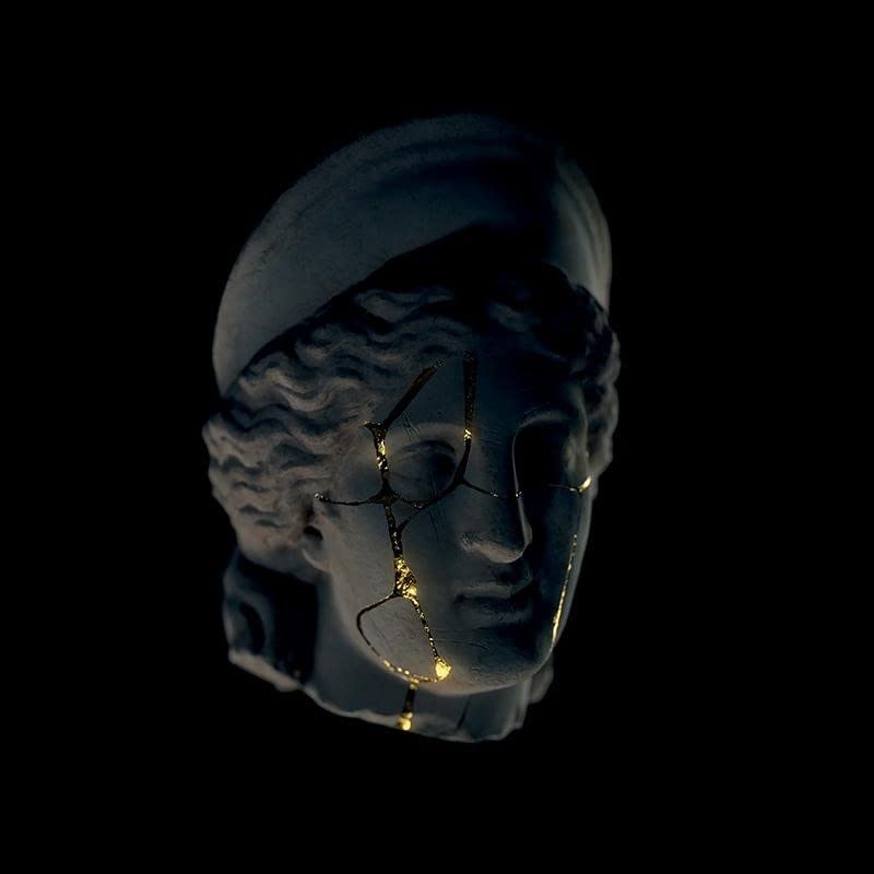 Broken classical bust with gold-filled cracks against a dark background.