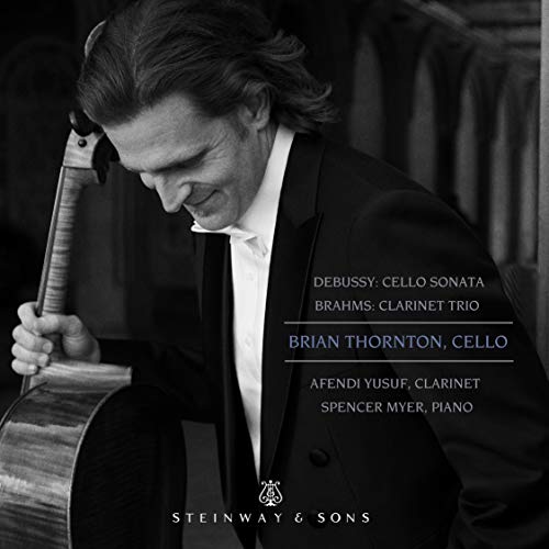 Black and white image of a man holding a cello, formal attire, with text overlay.