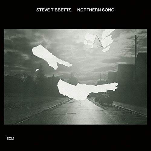 "Album cover with a black-and-white photo of a road and cloudy sky."