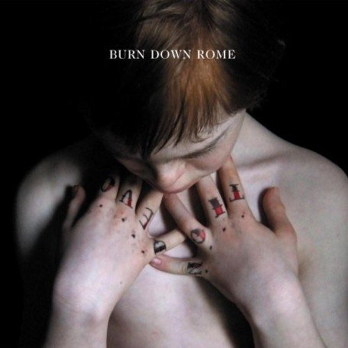 Album cover with a man, hands on chest, against a dark background.
