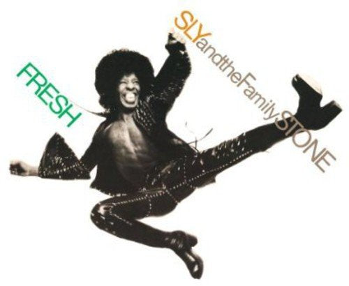 Album cover with a man jumping, wearing shiny black clothes, against a white background.