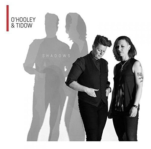 "Album cover with two women in black, shadowy silhouettes in the background."