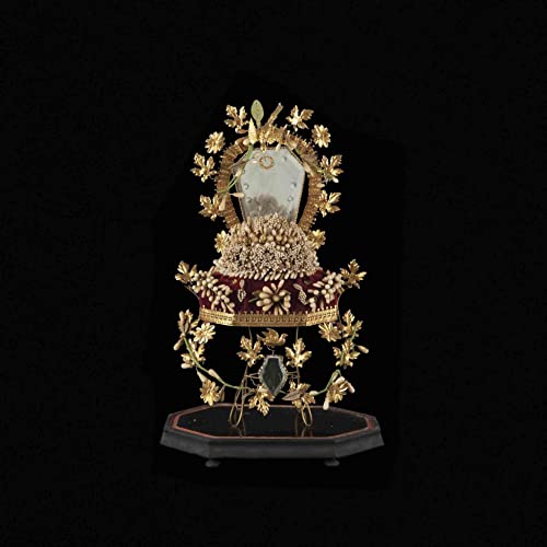 Ornate gold floral frame around a dark, reflective oval shape.