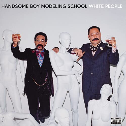 Album cover featuring two men and white mannequins in a studio.
