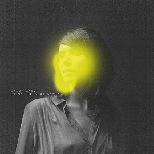 Album cover: Kira Skov portrait with yellow light effect, dark background.