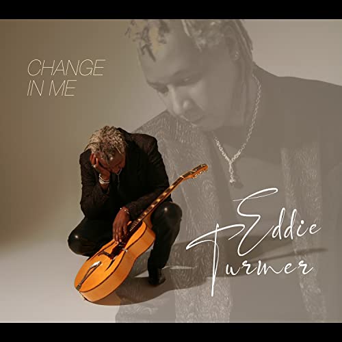 Album cover for Eddie Turner’s “Change In Me” featuring a musician with a guitar.