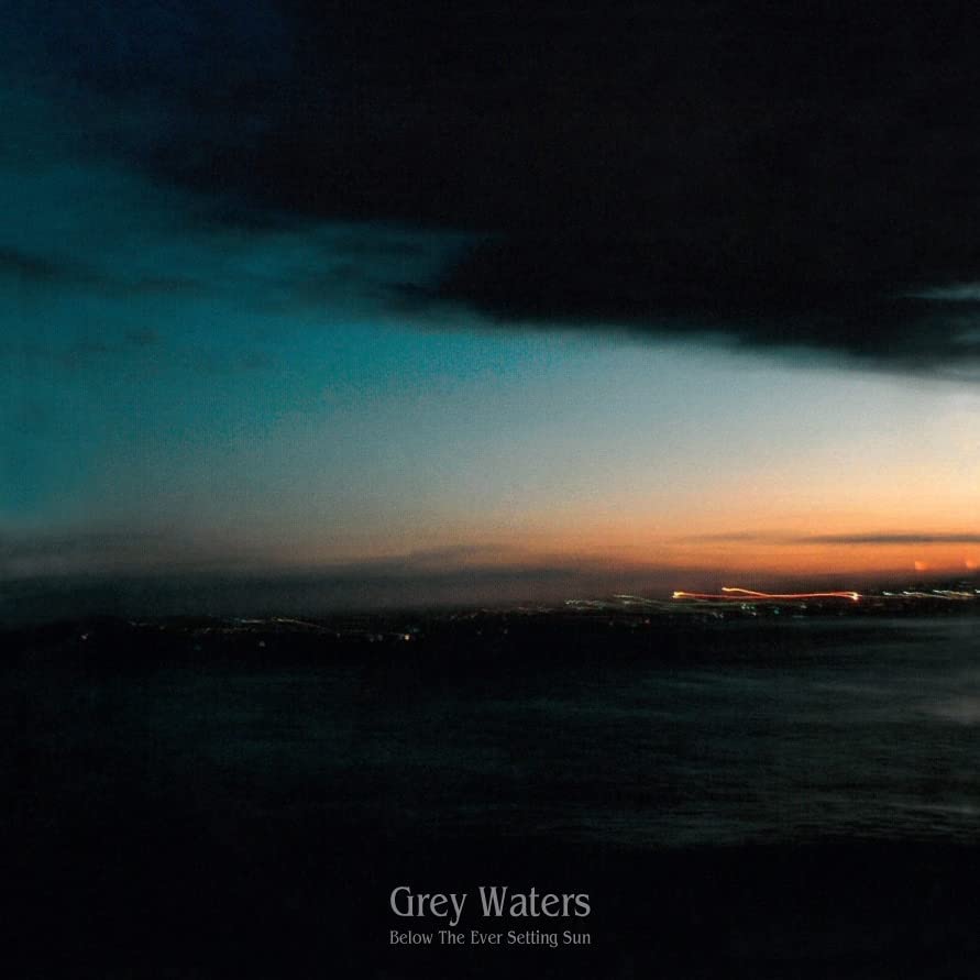 Album cover: dark seascape with orange sunset and band name text.