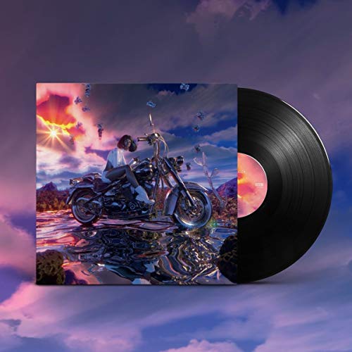 Vinyl record with cover art of a person on a motorcycle at sunset.