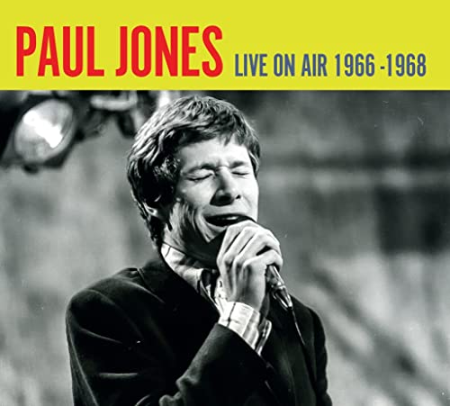 Black and white portrait of Paul Jones singing into a microphone.