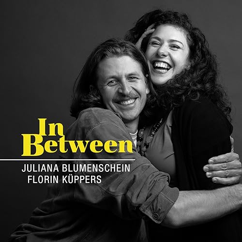 Black and white portrait of two smiling people embracing, album cover.
