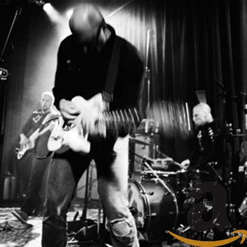 Black and white photo of a band performing live on stage.