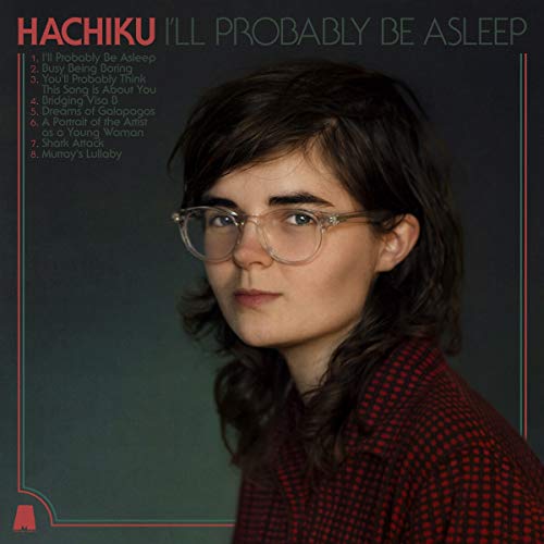 Album cover featuring a woman with glasses and dark wavy hair, wearing a red checked shirt.